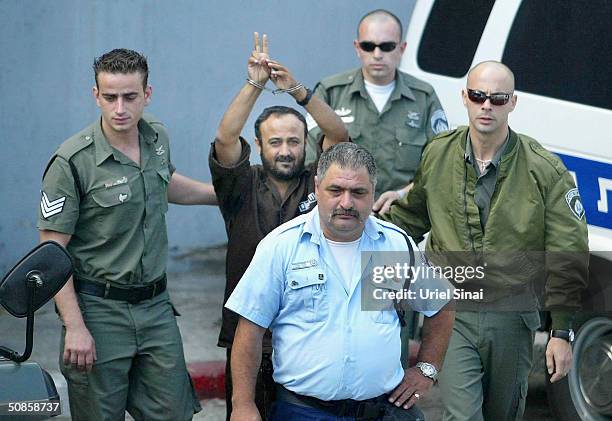 Marwan Barghoutti, head of the Palestinian Fatah Tanzim and Al-Aqsa Martyrs' Brigades, gestures as he is brought by Israeli police to the Tel Aviv...