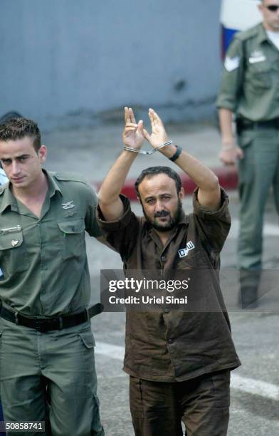 Marwan Barghoutti, head of the Palestinian Fatah Tanzim and Al-Aqsa Martyrs' Brigades, gestures as he is brought by Israeli police to the Tel Aviv...