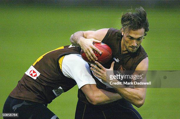 Angelo Lekkas of the Hawks attempts to break the tackle of Rayden Tallis during the Hawthorn Football Clubs training session at Ausdock Oval May 20,...