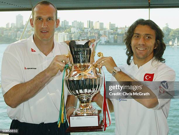 Socceroos Captain Mark Schwarzer and Turkey captain Bulent Korkman pose for photos with the Friendship and Freedom cup during the official welcoming...