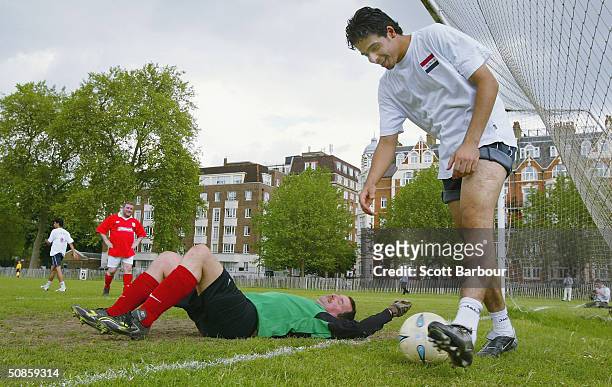 Huw Edwards , British member of parliament and goalkeeper for the Parliamentary Football team lies on his back after conceding a goal to the National...