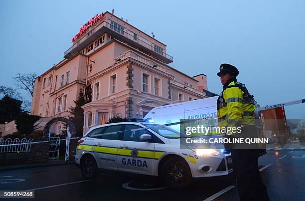 An Irish police officer stands at the police cordon sealing off the Regency Airport Hotel in Dublin on February 5, 2016 following a shooting...