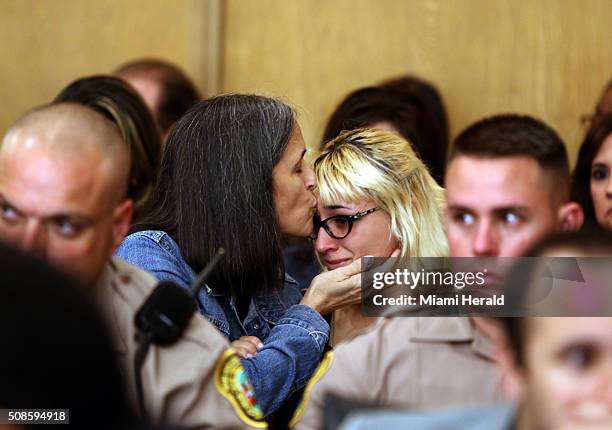 Carolyn Knox, mother of the slain woman, kisses a relative during the sentencing of Derek Medina on Feb. 5, 2016 in Miami.