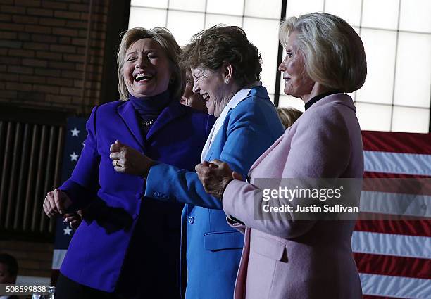 Democratic presidential candidate former Secretary of State Hillary Clinton dances with U.S. Sen. Jeanne Shaheen and Lilly Ledbetter during a canvas...