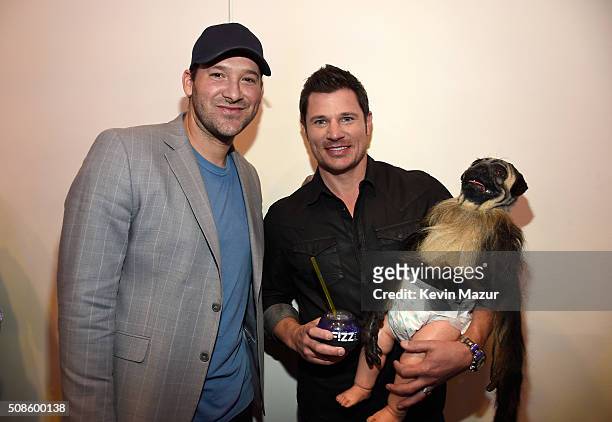 Tony Romo of the Dallas Cowboys, Nick Lachey and Puppy Monkey Baby visit the SiriusXM set at Super Bowl 50 Radio Row at the Moscone Center on...