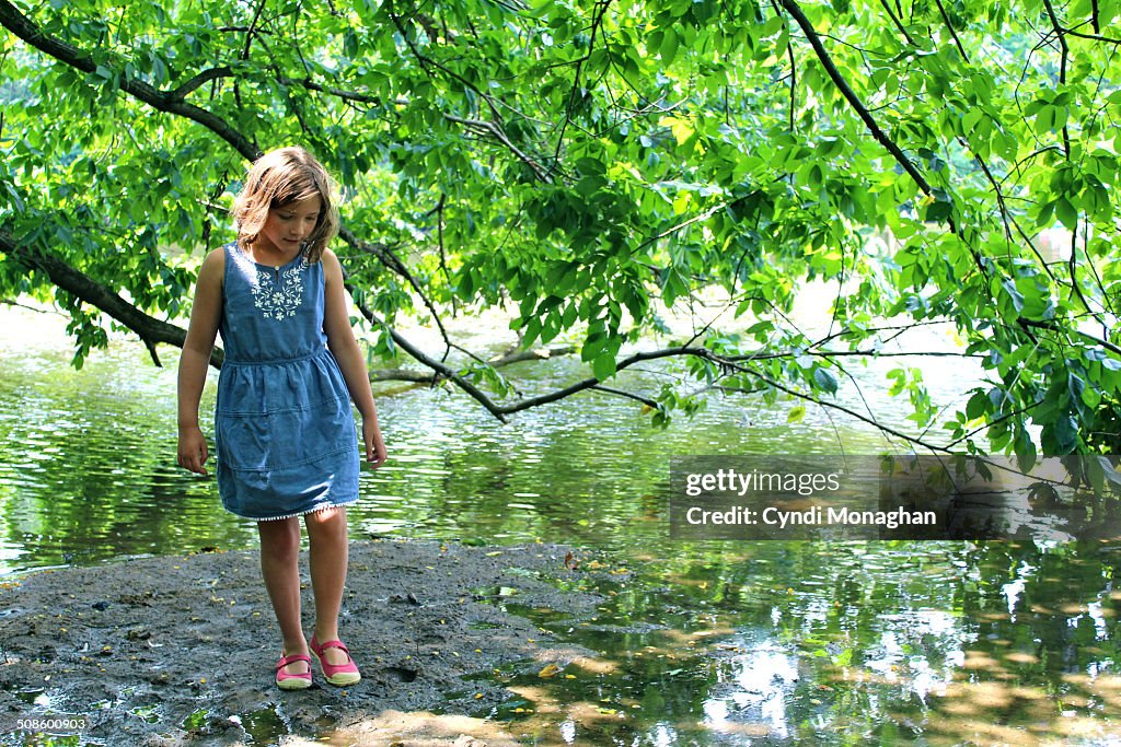 Girl Walking Next to Lake