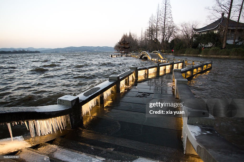 Illuminated icicles on bridge against the Leifeng Pagoda by the West Lake,Hangzhou,Zhejiang,China