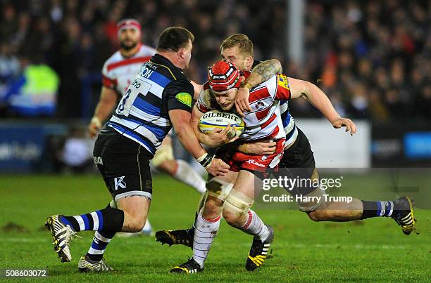 Tom Savage of Gloucester is tackled by David Wilson of Bath during the Aviva Premiership match between Bath Rugby and Gloucester Rugby at the...