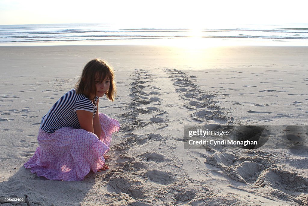 Girl Looking at Sea Turtle Tracks