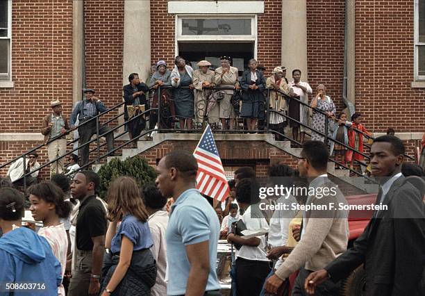 Church elders and children from the Mt. Zion AME Church watch as the Selma to Montgomery Civil Rights marchers pass in front on March 25, 1965 in...