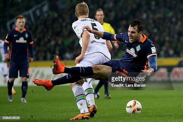 Martin Hinteregger of Moenchengladbach challenges Levin Mete Oeztunali of Bremen during the Bundesliga match between Borussia Moenchengladbach and...