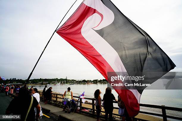 The Maori flag is marched along the waterfront on February 6, 2016 in Waitangi, New Zealand. The Waitangi Day national holiday celebrates the signing...