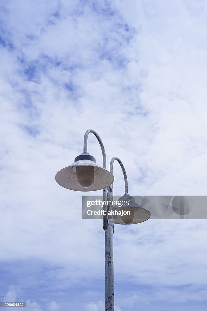 Light post on clear blue sky background