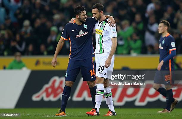 Claudio Pizarro of Bremen hughs Martin Stranzl of Moenchengladbach after the Bundesliga match between Borussia Moenchengladbach and Werder Bremen at...