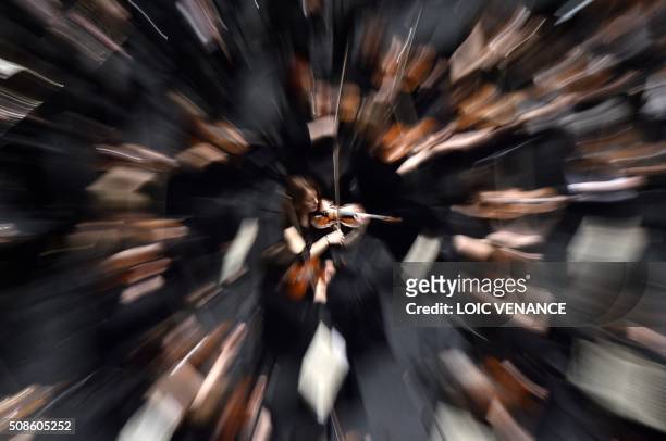 Violinists of the Ural Philharmonic Orchestra perform during the "Folle Journee de Nantes" classical music festival in Nantes, western France, on...