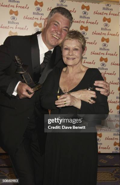 Matthew Kelly and Dame Judi Dench attend the 2004 Laurence Olivier Awards at The Park Lane Hilton Hotel on February 22, 2004 in London.