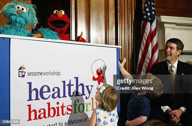 Sesame Street character Elmo and Rosita perform for Senate Majority Leader Bill Frist and toddlers including Gary Grutzik of Annandale, Virginia,...