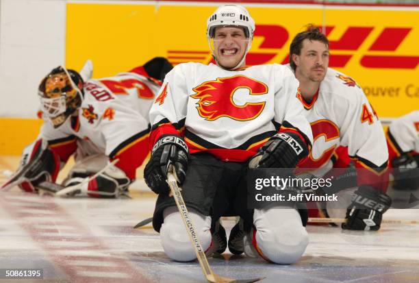 Ville Nieminen of the Calgary Flames grimaces as he stretches during warm up prior to game five against the Vancouver Canucks in the first round of...