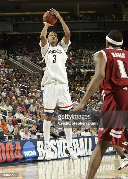 Charlie Villanueva of the University of Connecticut Huskies shoots over Chuck Davis of the Alabama Crimson Tide during the fourth round of the NCAA...