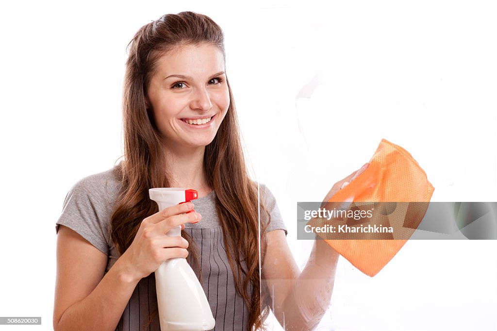 Happy woman in gloves cleaning window