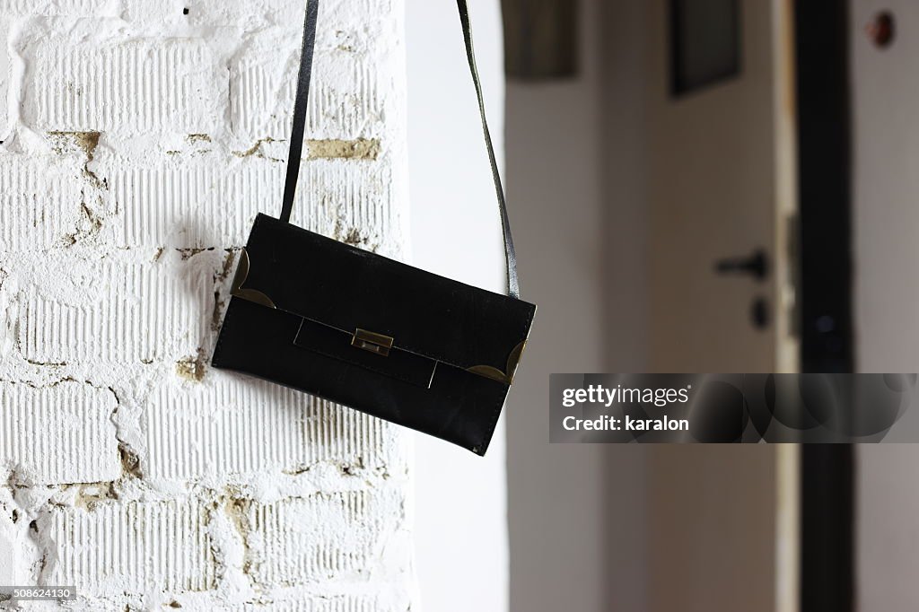 Black handbag on the wall