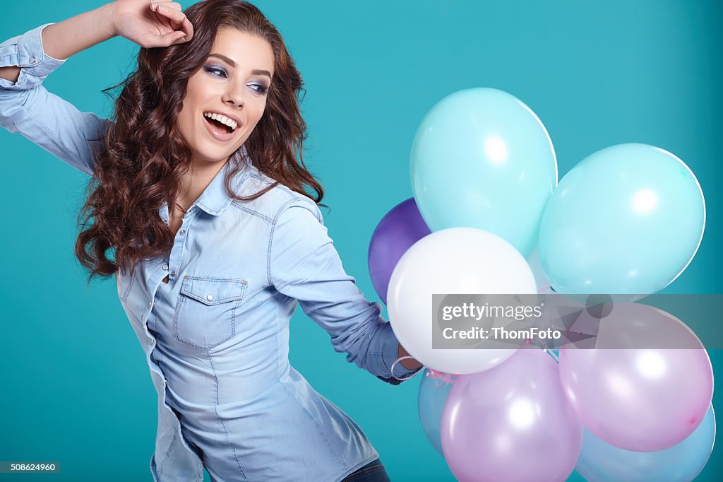 Young pretty woman with colored balloons