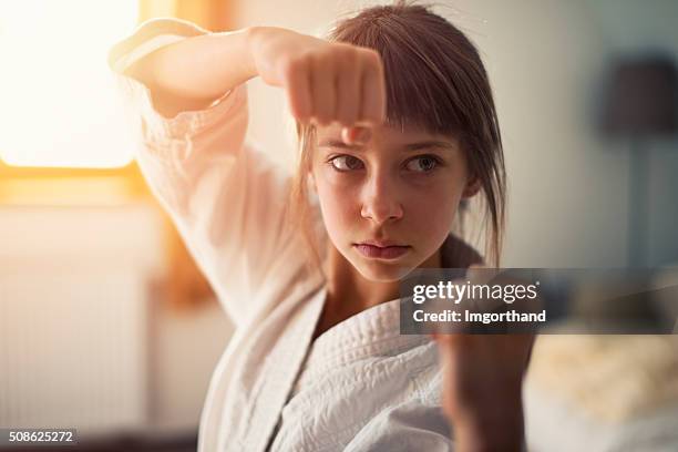 little girl practicing karate - self defense 個照片及圖片檔