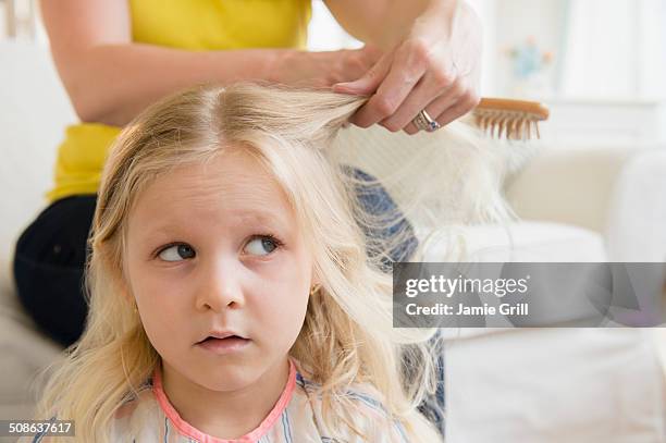 mother brushing daughters hair - brushing hair stock pictures, royalty-free photos & images