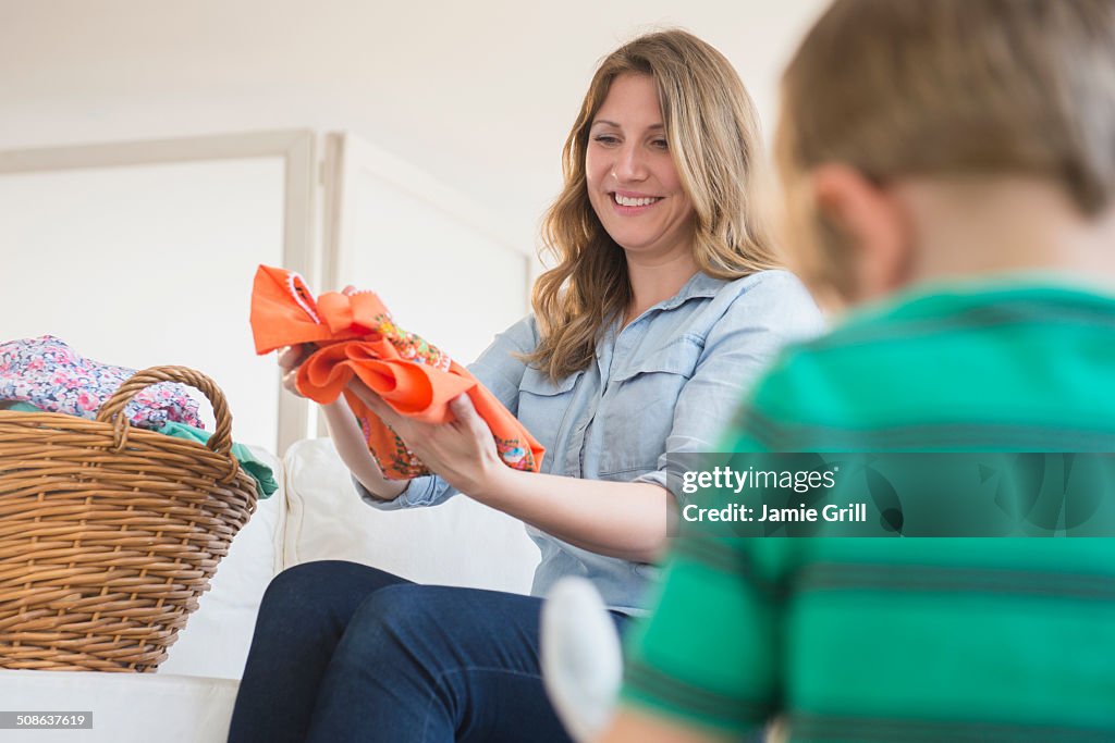 Mother folding laundry