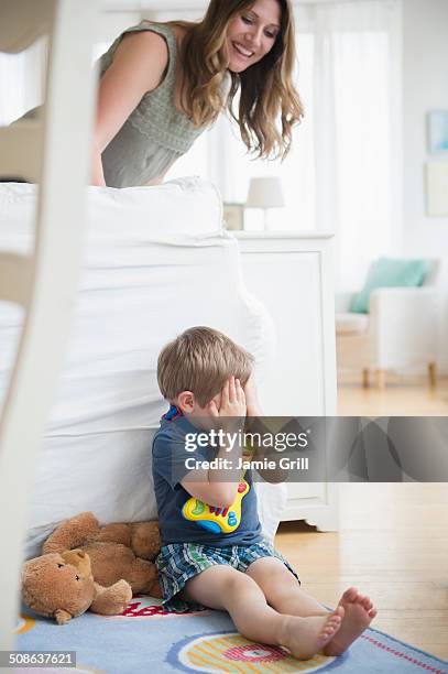 boy hiding from mother - hidw and seek stock pictures, royalty-free photos & images