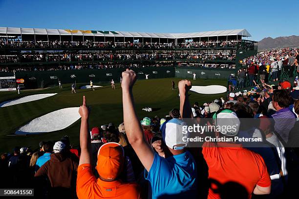 Fans react as Rickie Fowler putts on the 16th green during the second round of the Waste Management Phoenix Open at TPC Scottsdale on February 5,...