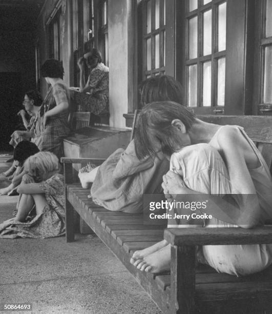 Patients sitting in the insane asylum.