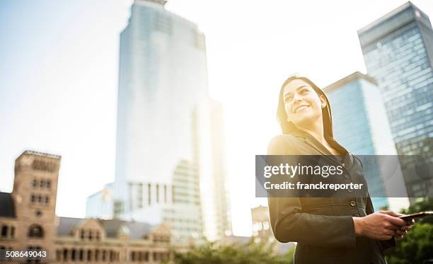 business woman with arm crossed on urban scene - smart building stock pictures, royalty-free photos & images