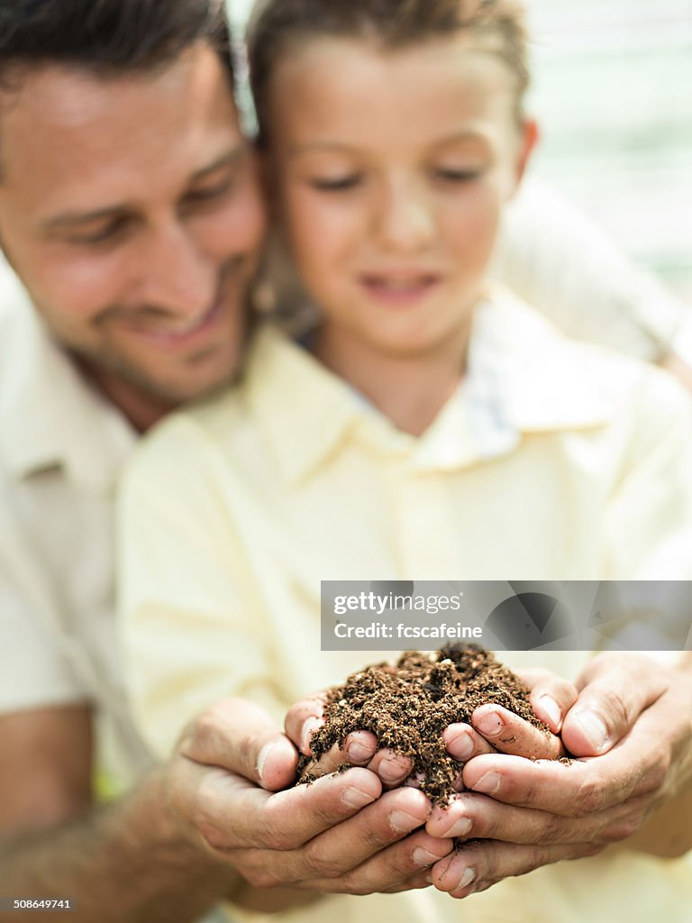 Father educate son to care a plant