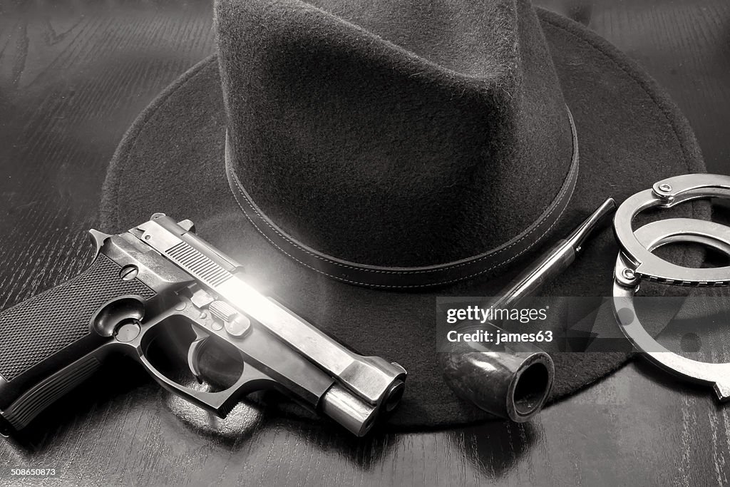 Detective team, semiautomatic pistol handcuffs hat and pipe