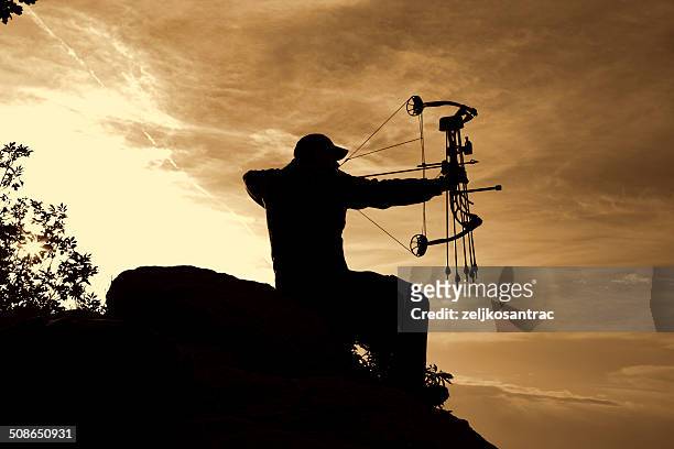 bowhunter in sunrise - arrow bow and arrow stock pictures, royalty-free photos & images