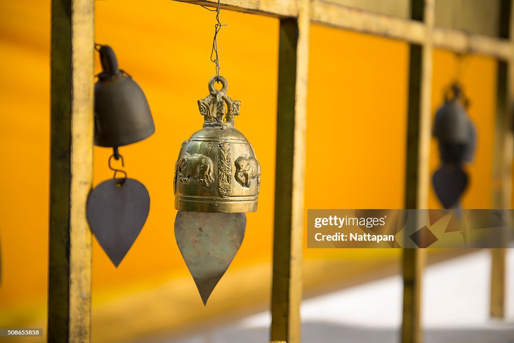 Row of golden bells in buddhist temple