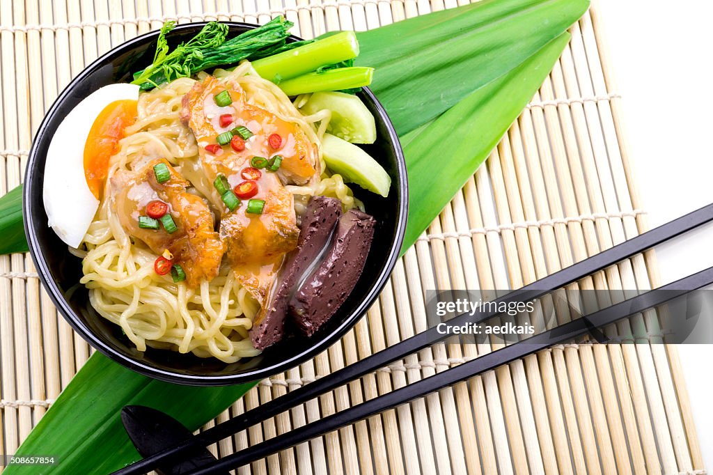 Ramen noodle japanese style in broth with vegetables and meat.