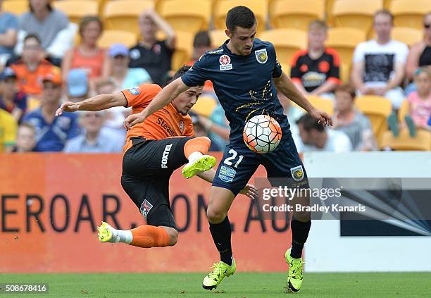 Michael Neill of the Mariners is challenged by Dimitri Petratos of the Roar during the round 18 A-League match between the Brisbane Roar and Central...