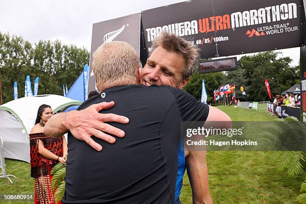 Jonas Buud of Sweden receives a hug from event organiser Paul Charteris after winning the Tarawera Ultramarathon on February 6, 2016 in Rotorua, New...