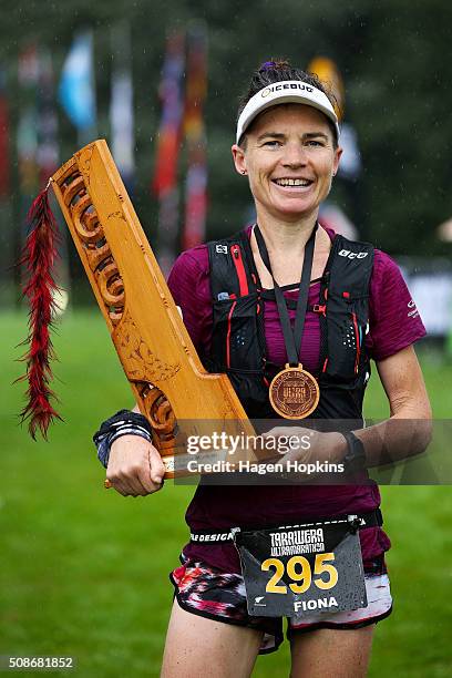 Fiona Hayvice of New Zealand celebrates with the winner's trophy after winning the Tarawera Ultramarathon on February 6, 2016 in Rotorua, New Zealand.