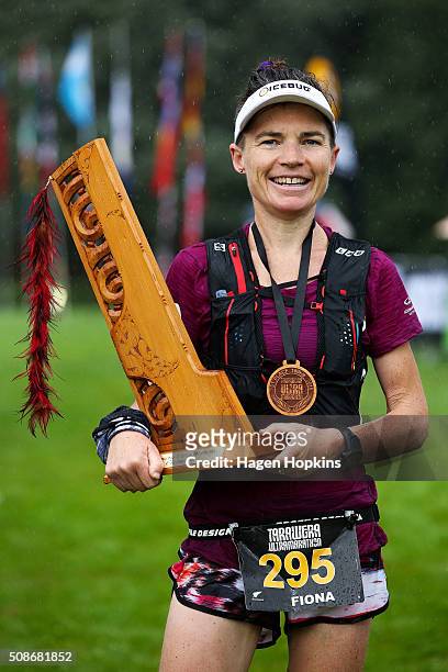 Fiona Hayvice of New Zealand celebrates with the winner's trophy after winning the Tarawera Ultramarathon on February 6, 2016 in Rotorua, New Zealand.