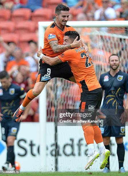 Jamie Maclaren of the Roar celebrates with team mate Dimitri Petratos after scoring a goal during the round 18 A-League match between the Brisbane...