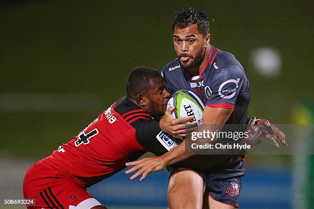 Karmichael Hunt of the Reds is tackled during the Super Rugby pre-season match between the Reds and the Crusaders at Ballymore Stadium on February 6,...