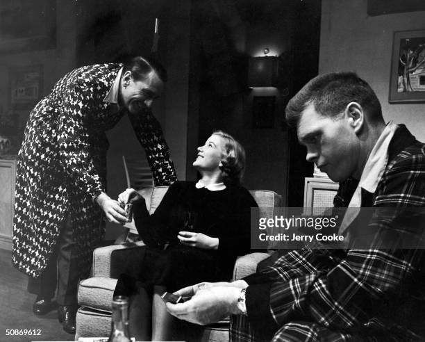 Barbara Bel Geddes, Barry Nelson, and Donald Cook acting out a dramatic moment in the show "The Moon is Blue."