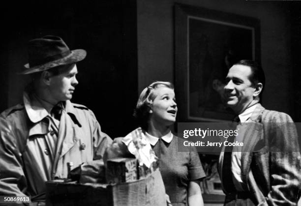 Barbara Bel Geddes, Barry Nelson, and Donald Cook acting out a dramatic moment in the show "The Moon is Blue."