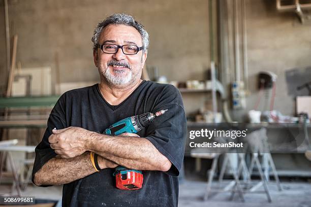 real people - worker with drill - carpenter stock pictures, royalty-free photos & images