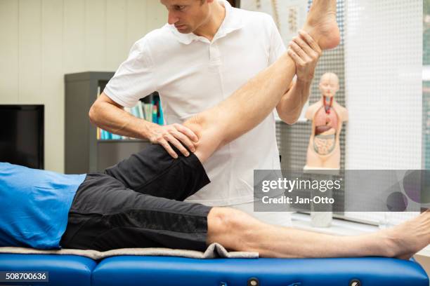 doctor performing lasegue test - neuropathy stock pictures, royalty-free photos & images