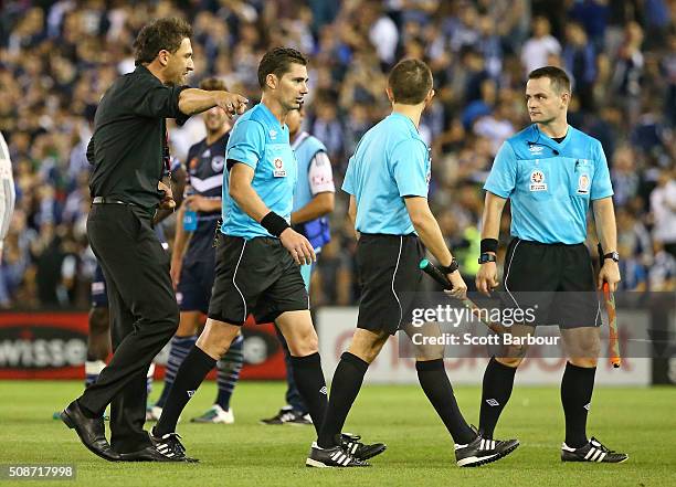 Tony Popovic, coach of the Wanderers speaks with referee Ben Williams as they leave the field after the round 18 A-League match between the Melbourne...