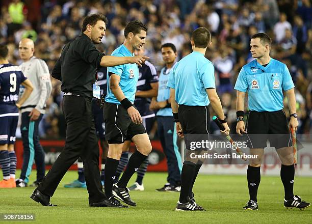 Tony Popovic, coach of the Wanderers speaks with referee Ben Williams as they leave the field after the round 18 A-League match between the Melbourne...